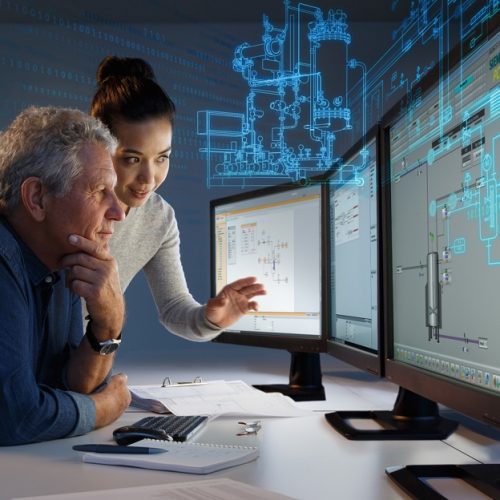 a man and woman watch a screen monitoring machines